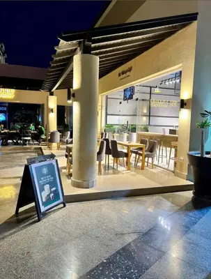 a restaurant with tables and chairs in a building at Hotel Apartment 1 very nice and quiet hurghada in Hurghada