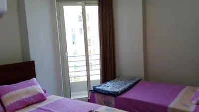 a bedroom with two beds and a window with a view at princess resort ,arch angilos Hurghada in Hurghada