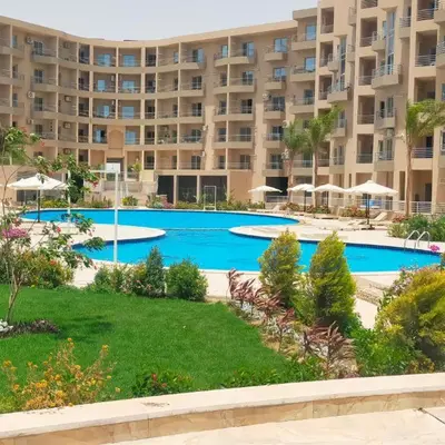a large apartment building with a large swimming pool at princess resort ,arch angilos Hurghada in Hurghada