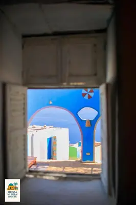 a box with a picture of a blue building at Heissa Nubian Hostel in Aswân Reservoir Colony