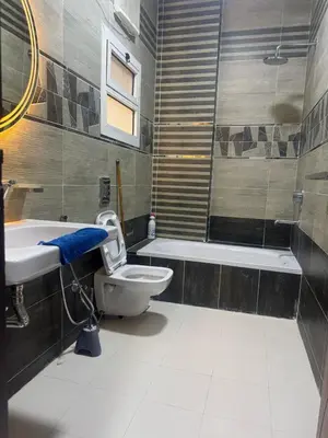 a bathroom with a toilet and a sink and a tub at Inter Prime apartment 1 in Hurghada