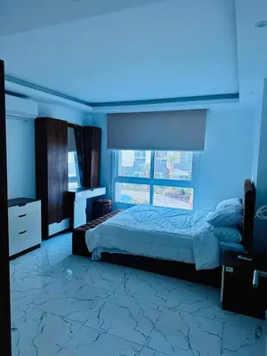 a bedroom with a large bed and a blue light at 005 flamingo building Cozy appartement-two beds-1st floor with elevator in Hurghada