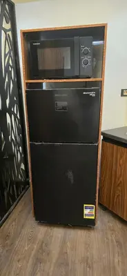 a microwave oven sitting on top of a refrigerator at Dive Hostel Hurghada Sea Light in Hurghada