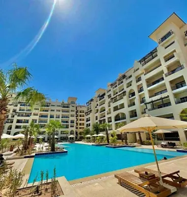 a large apartment building with a large swimming pool at Modern apartment in Hurghada al dau heights 3314 in Hurghada