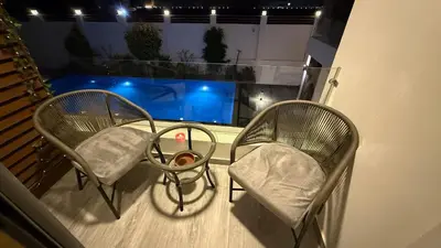 two chairs sitting on top of a balcony with a table at Imperial Resort Hurghada in Hurghada