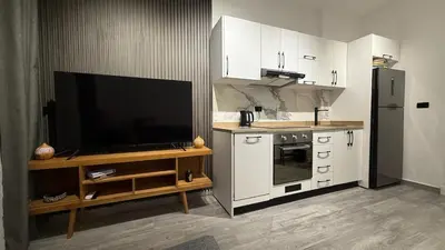 a kitchen with a flat screen tv on a counter at Imperial Resort Hurghada in Hurghada