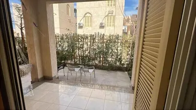 a balcony with two chairs and a fence at Apartment for rent 2 bed rooms in Hurghada