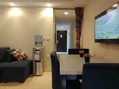 a living room with a table and a large screen at Selena Bay Resort in Hurghada