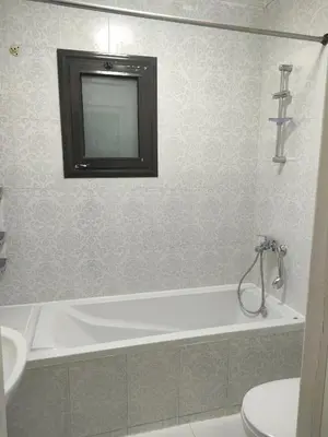 a bathroom with a tub and a toilet and a sink at Apartment for rent in Hurghada