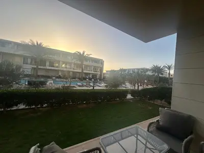 a view of a resort with a lawn and a building at G Cribs Hotel Apartment 2BR in Hurghada