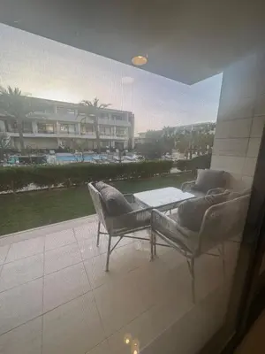 a view of a patio with two chairs and a table at G Cribs Hotel Apartment 2BR in Hurghada