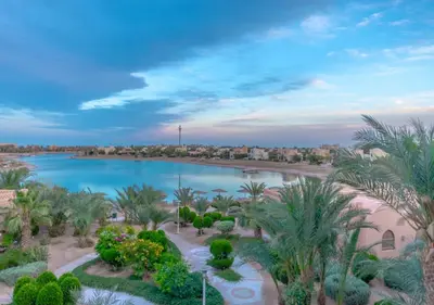 an aerial view of a pool with palm trees at Dreamy 1BR in Italian Compound, Nubia, El Gouna in Hurghada