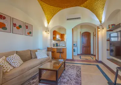 a living room with a couch and a table at Dreamy 1BR in Italian Compound, Nubia, El Gouna in Hurghada