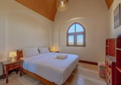 a bedroom with a large bed and a window at Dreamy 1BR in Italian Compound, Nubia, El Gouna in Hurghada