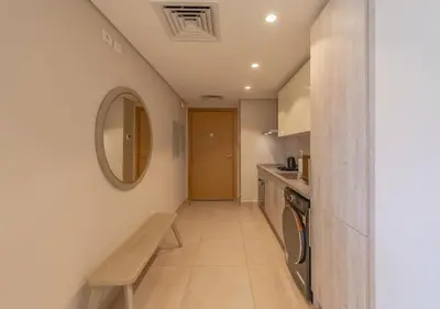 a hallway of a kitchen with a bench and a mirror at Sea View 2BR Mangroovy Gouna I Swimming Pool and Red Sea Beach in Hurghada