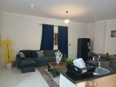 a living room with a couch and a table at Cozy Apartment in Hurghada