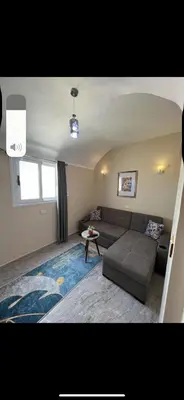 a living room with a couch and a table at Palace view in Hurghada
