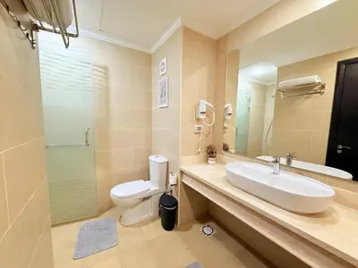 a bathroom with a sink and a toilet and a shower at Luxury hotel apartment 2rooms with triple sea view in Hurghada