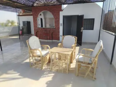 a patio with a table and chairs on a patio at Mena Palace Nile View in Luxor