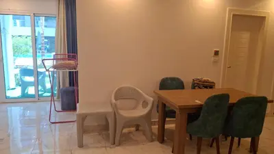 a dining room with a wooden table and chairs at Fanadir Bay apartment in Hurghada