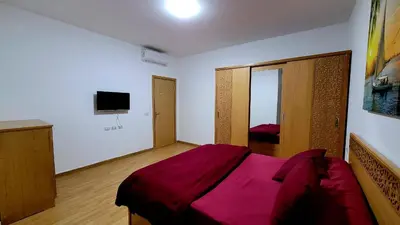 a bedroom with a large bed with a red blanket at touristic centre hurghada in Hurghada