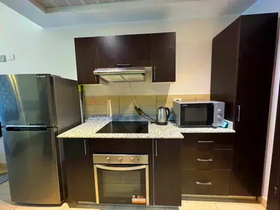 a kitchen with a stainless steel refrigerator and a microwave at Golden Aldau Heights studio Hurghada 1019 in Hurghada