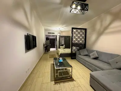 a living room with a couch and a table at Golden Aldau Heights studio Hurghada 1019 in Hurghada