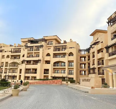 a large apartment building with a street in front of it at Studio in Dow Heights Compound in Hurghada