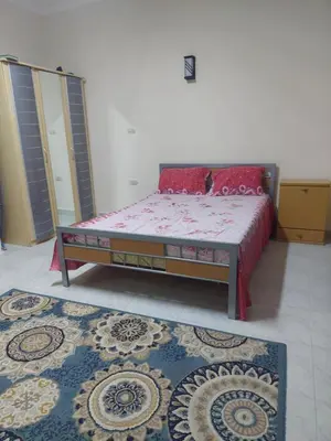 a bedroom with a bed and a rug in a room at Hurghada in Hurghada