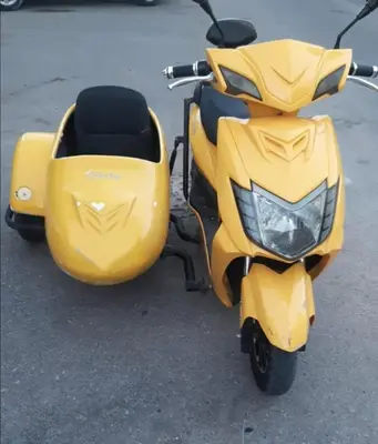 a yellow scooter parked in a parking lot at Mangroovy- 1br GF Waterfront Glitzy direct pool in Hurghada