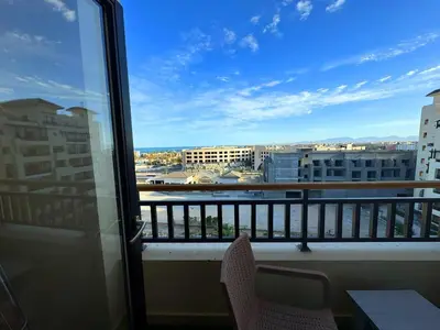a balcony with chairs and a view of a city at More Relaxation Aldau Heights Studio in Hurghada in Hurghada
