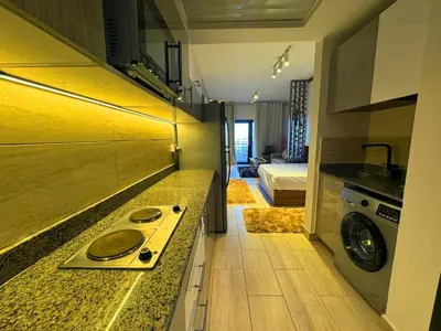 a kitchen with a washer and dryer in a room at More Relaxation Aldau Heights Studio in Hurghada in Hurghada