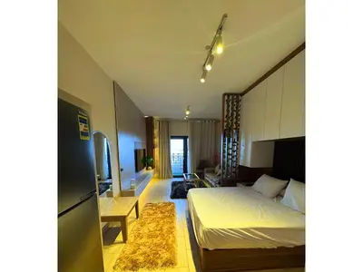 a bedroom with a bed and a living room at More Relaxation Aldau Heights Studio in Hurghada in Hurghada