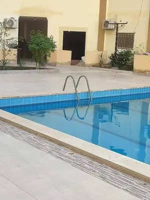 a blue swimming pool with a metal object in it at كمبوند سكاي 2 in Hurghada