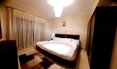a bedroom with a white bed and a window at Coral Aldau Heights one bedroom apartment in hurghada in Hurghada
