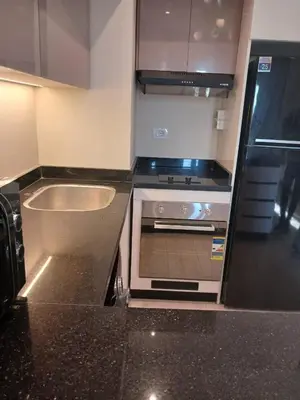 a kitchen with a stove and a sink in it at Crystal Aldau Heights one bedroom apartment in Hurghada in Hurghada