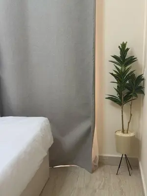 a bedroom with a bed and a potted plant at Crystal Aldau Heights one bedroom apartment in Hurghada in Hurghada