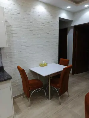 a white table and chairs in a room at Princess Resort apartment Hurghada in Hurghada