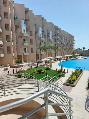 a view of a large apartment building with a swimming pool at Princess Resort apartment Hurghada in Hurghada