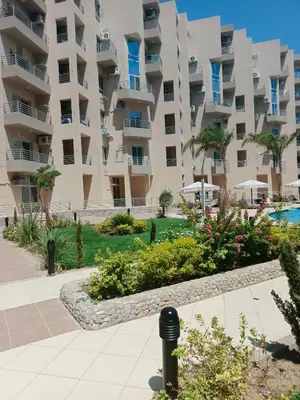 a large apartment building with a garden in front of it at Princess Resort apartment Hurghada in Hurghada