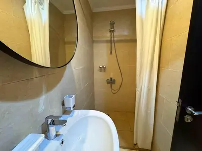 a bathroom with a sink and a shower with a mirror at Aldau Heights studio in Hurghada gol in Hurghada