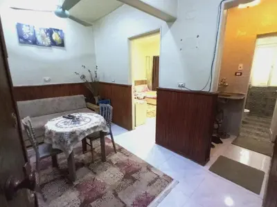 a room with a table and a chair in a room at Aswan cozy apartment in Aswan