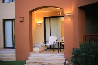 a porch of a house with a table and chairs at Port ghalib in Abu Dabab