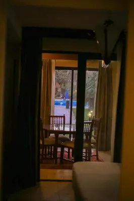 a dining room with a table and chairs and a window at Port ghalib in Abu Dabab
