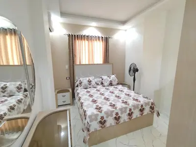 a small bedroom with a bed and a mirror at شقه للايجار اليومى او الشهرىApartment for daily or monthly rent in Hurghada