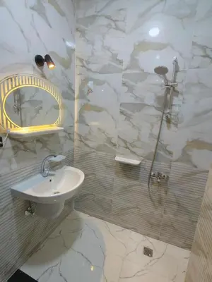 a white bathroom with a sink and a shower at شقه للايجار اليومى او الشهرىApartment for daily or monthly rent in Hurghada