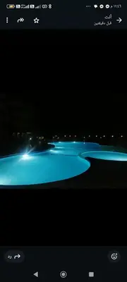 a view of a river at night with blue lights at Luxor Egypt in Al Baghdādī