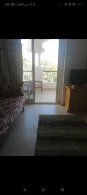 a room with a bed and a view of a balcony at Luxor Egypt in Al Baghdādī