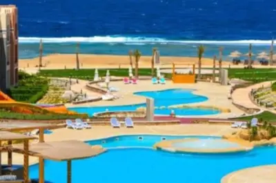 a large swimming pool next to a beach at Oysterbay in Marsa Alam