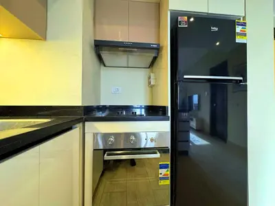 a kitchen with a stainless steel stove and a refrigerator at Beauty Aldau heights in Hurghada